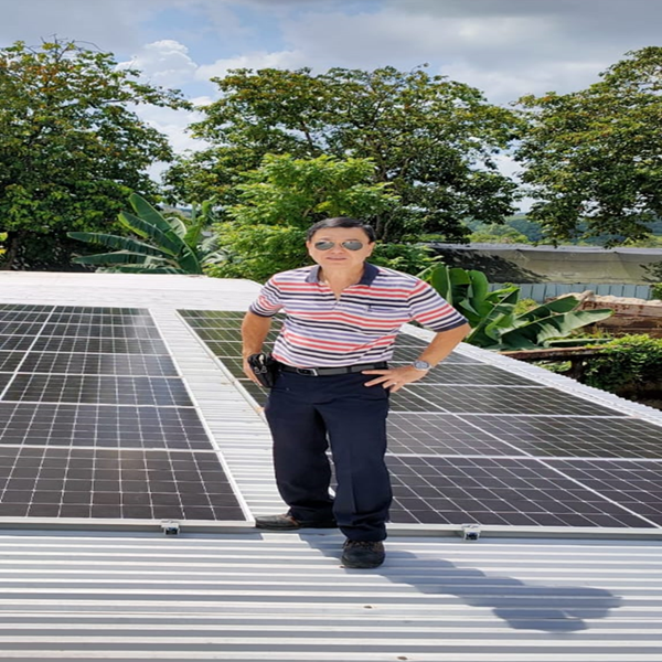 Technician installing solar panels on a roof